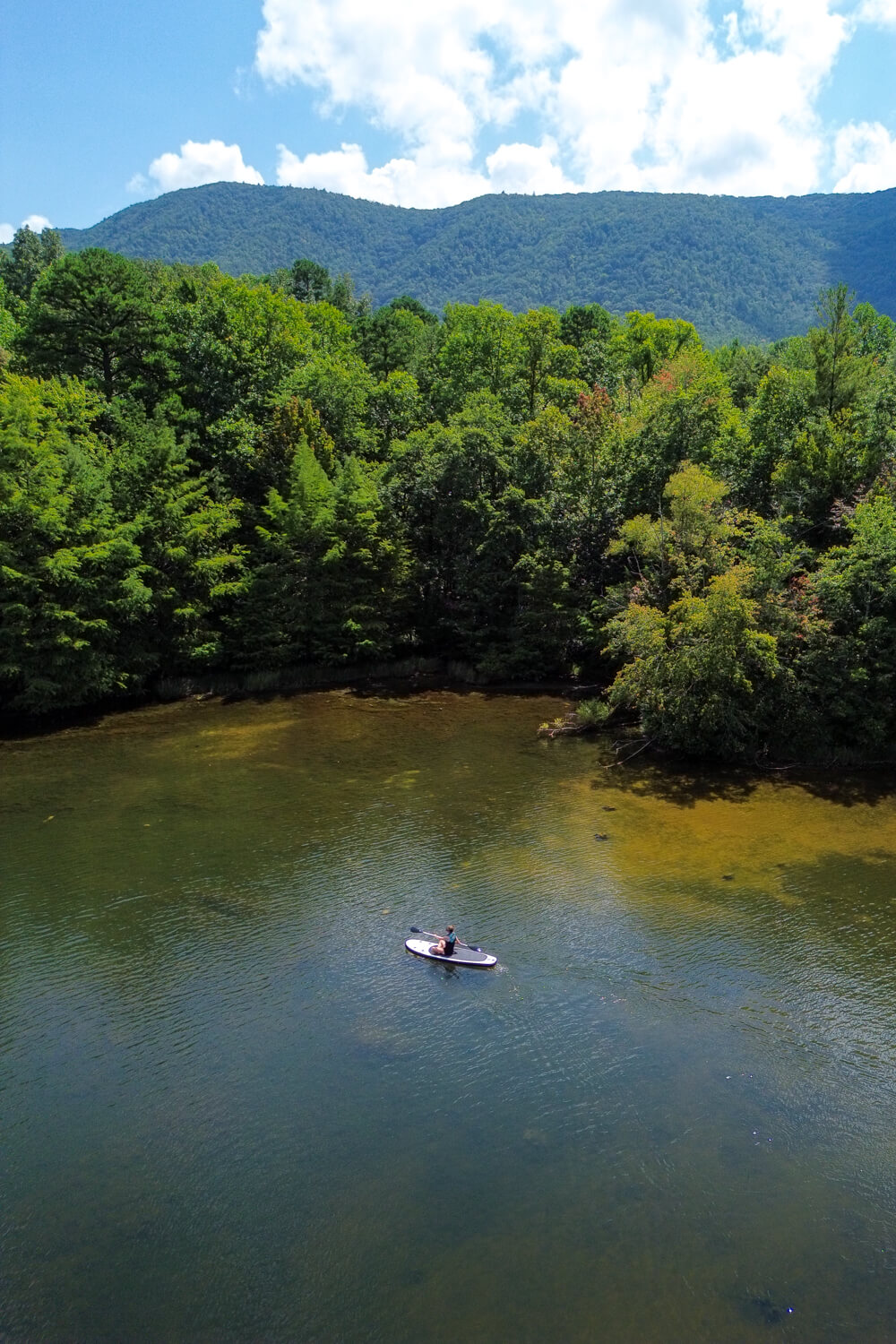girl on an SUP paddling indian boundary lake in tennessee